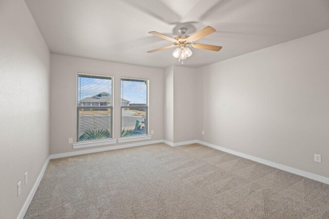 spare room with light carpet and ceiling fan