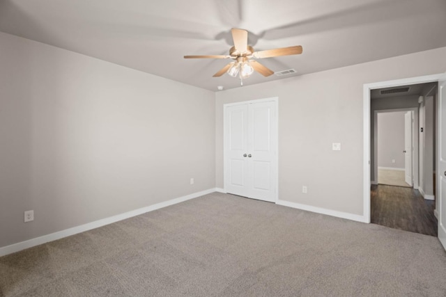 unfurnished bedroom featuring a closet, ceiling fan, and carpet