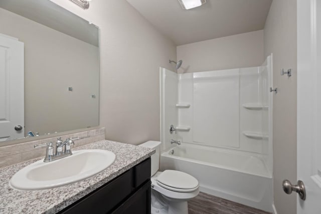 full bathroom with washtub / shower combination, vanity, toilet, and wood-type flooring