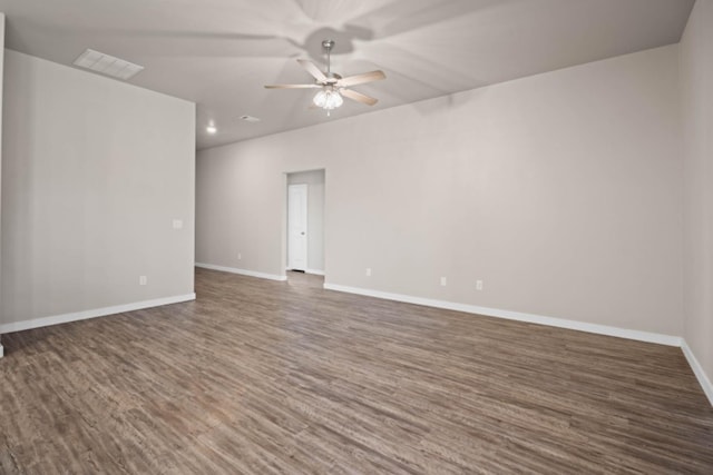 empty room featuring dark wood-type flooring and ceiling fan