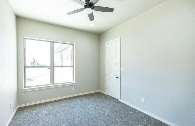 carpeted spare room with ceiling fan