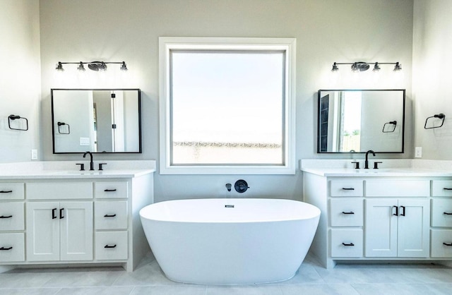 bathroom featuring vanity and a bath