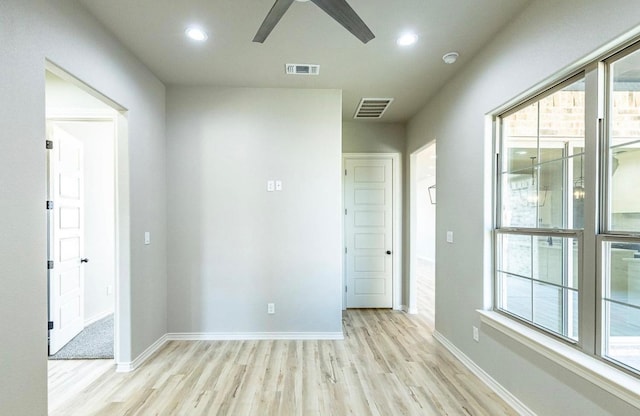 spare room featuring ceiling fan and light hardwood / wood-style flooring