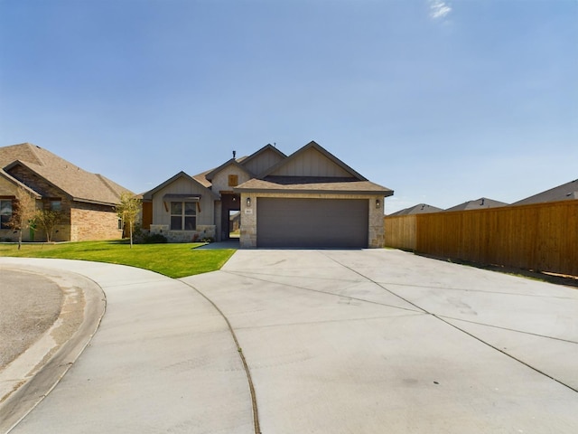 view of front of house featuring a garage and a front lawn