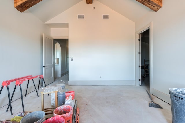 interior space featuring beamed ceiling, visible vents, and concrete flooring