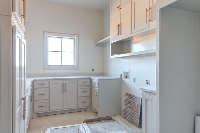 laundry room featuring washer hookup and cabinet space