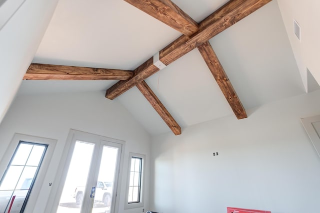 interior details featuring beam ceiling, visible vents, and french doors