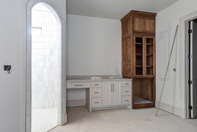 full bath featuring concrete floors and walk in shower