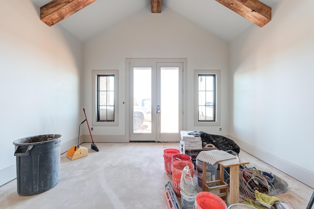 interior space featuring a wealth of natural light, french doors, baseboards, and vaulted ceiling with beams