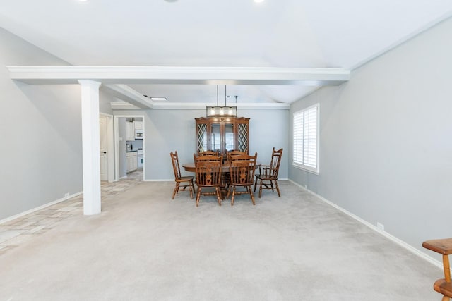 dining area featuring beamed ceiling and carpet floors