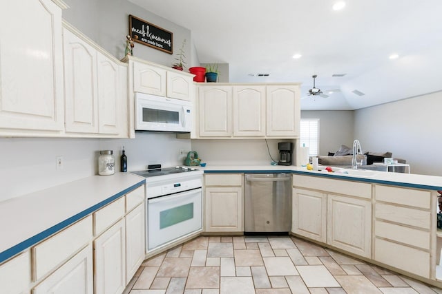 kitchen with sink, white appliances, kitchen peninsula, and ceiling fan