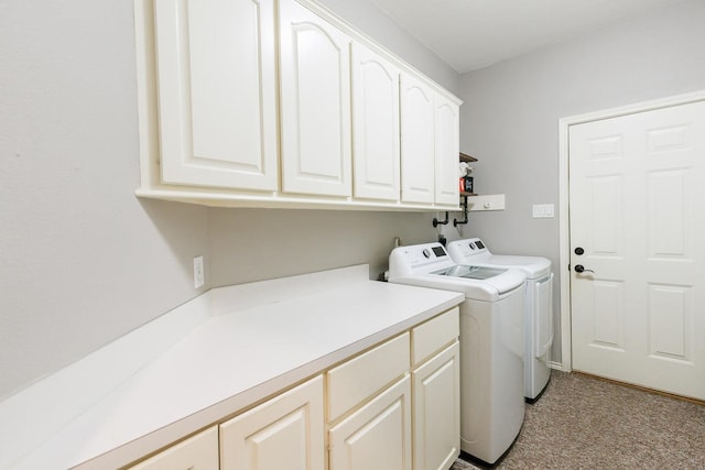 washroom with light carpet, cabinet space, and washing machine and clothes dryer