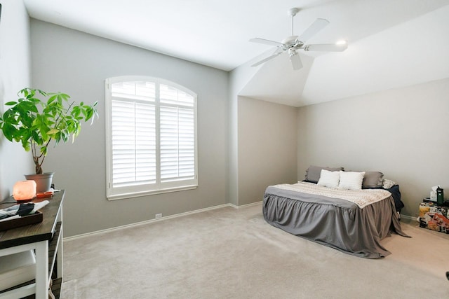 bedroom featuring vaulted ceiling, ceiling fan, baseboards, and light colored carpet