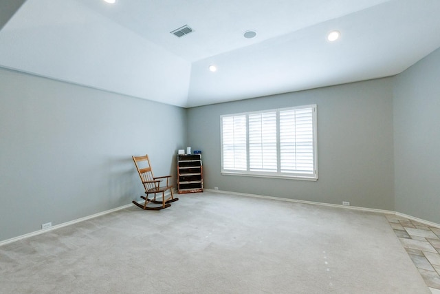 unfurnished room featuring light colored carpet and vaulted ceiling