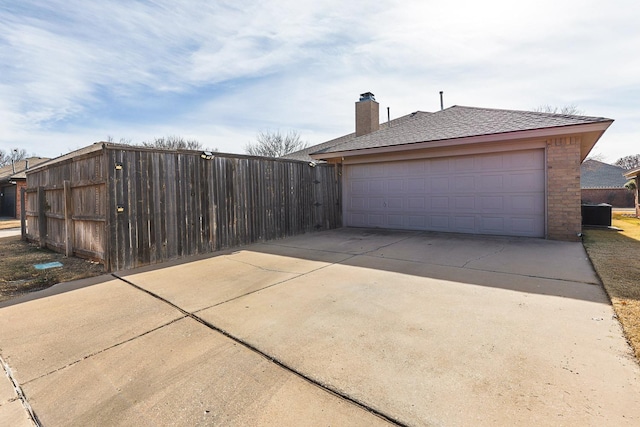 detached garage featuring fence