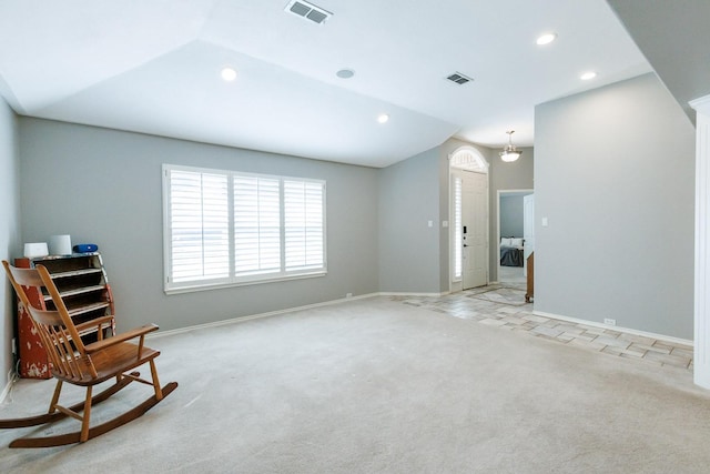 sitting room featuring light colored carpet and lofted ceiling