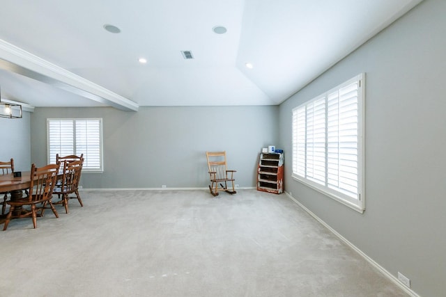 sitting room featuring carpet floors and vaulted ceiling