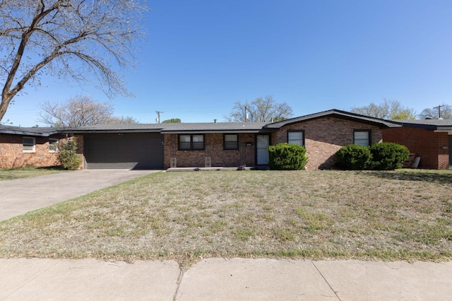 ranch-style home featuring a garage and a front lawn