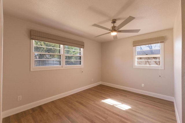 empty room with hardwood / wood-style flooring and ceiling fan