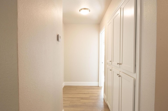 hallway with light wood-type flooring