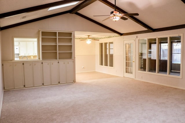 carpeted empty room with vaulted ceiling with beams and ceiling fan