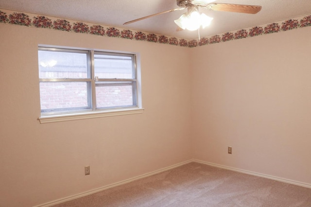 empty room with a textured ceiling, ceiling fan, and carpet flooring