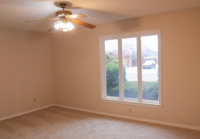 unfurnished room featuring ceiling fan and carpet flooring