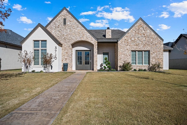 view of front of property featuring french doors and a front lawn