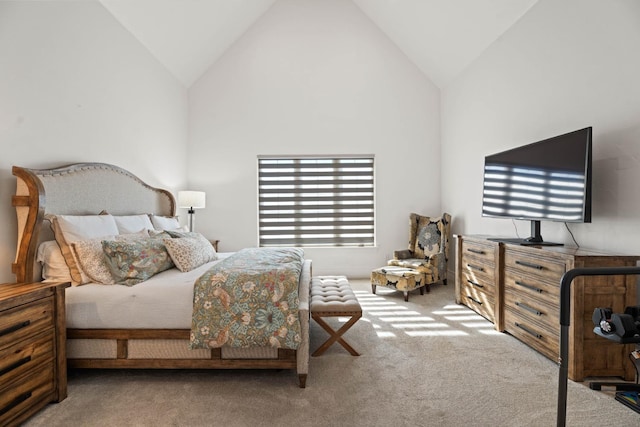 carpeted bedroom featuring high vaulted ceiling