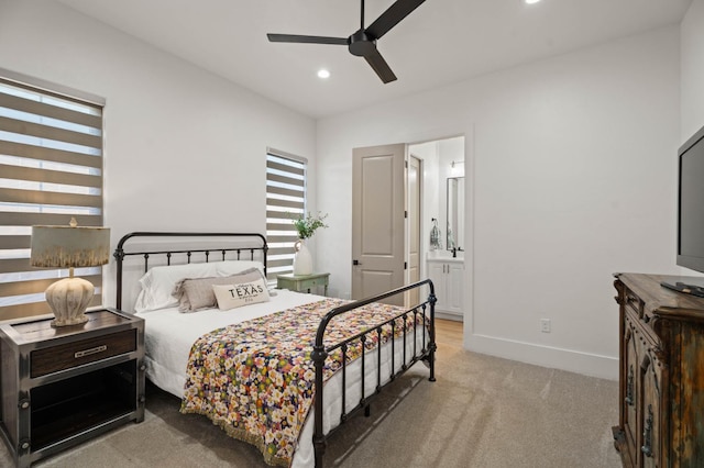 carpeted bedroom featuring ceiling fan and ensuite bath