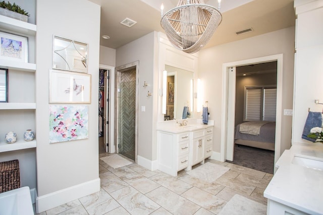 bathroom featuring a chandelier, vanity, visible vents, baseboards, and marble finish floor