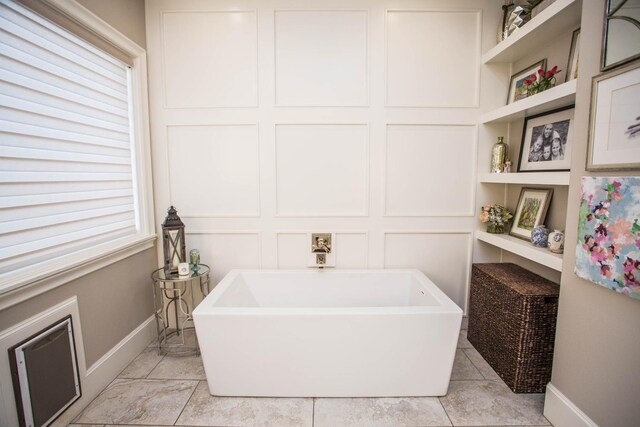 5005 120th St, Lubbock, TX 79424 - bathroom with baseboards and a freestanding bath