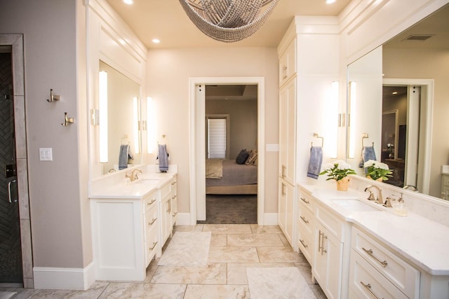 ensuite bathroom with recessed lighting, a sink, visible vents, and connected bathroom