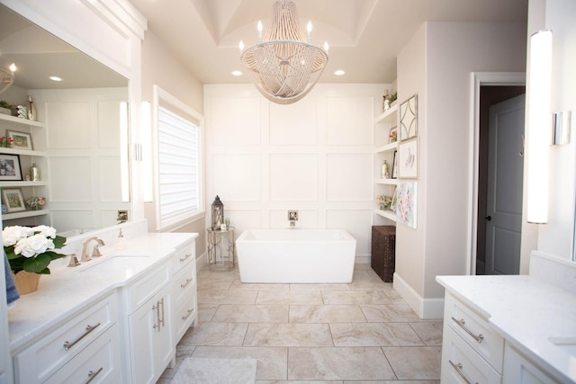 bathroom featuring built in features, recessed lighting, a decorative wall, a freestanding bath, and vanity