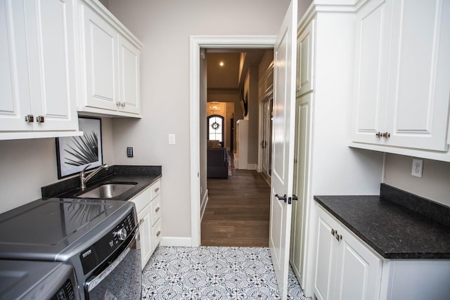 5005 120th St, Lubbock, TX 79424 - laundry room with separate washer and dryer, cabinet space, and light tile patterned floors