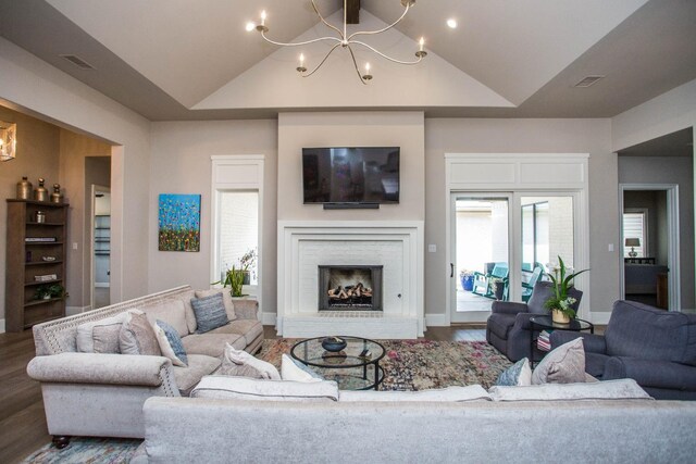 5005 120th St, Lubbock, TX 79424 - living room featuring a chandelier, lofted ceiling, wood finished floors, and a brick fireplace