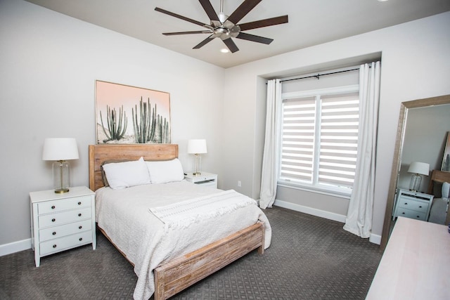 bedroom featuring dark carpet, baseboards, and ceiling fan