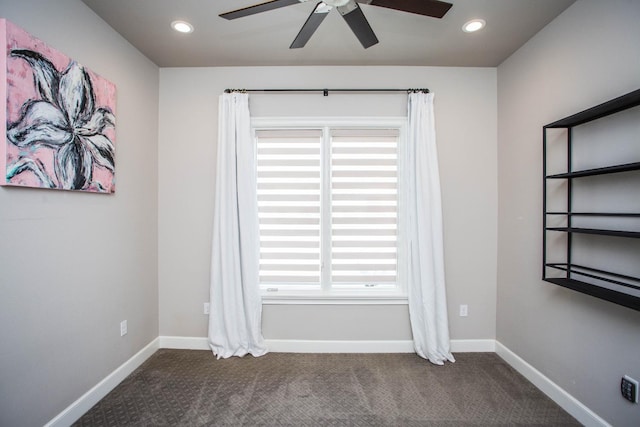 spare room featuring dark colored carpet, baseboards, and recessed lighting