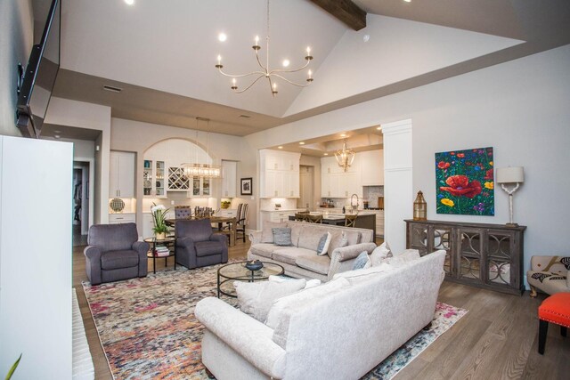 5005 120th St, Lubbock, TX 79424 - living room featuring a chandelier, wood finished floors, beamed ceiling, high vaulted ceiling, and recessed lighting