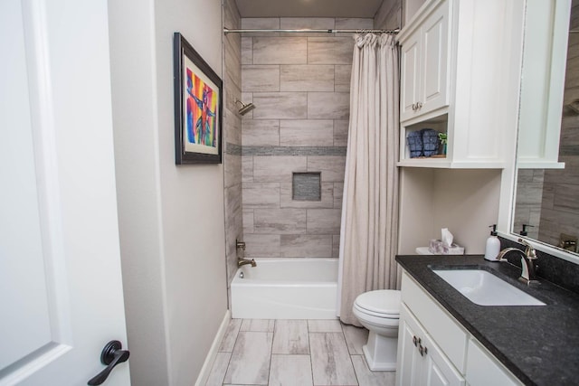 bathroom featuring toilet, shower / bath combination with curtain, and vanity