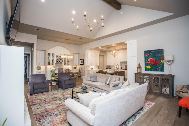 living room featuring a chandelier, beamed ceiling, high vaulted ceiling, and wood finished floors