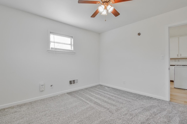 carpeted empty room featuring ceiling fan