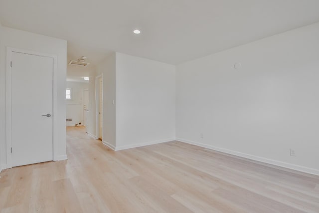 spare room featuring light hardwood / wood-style floors