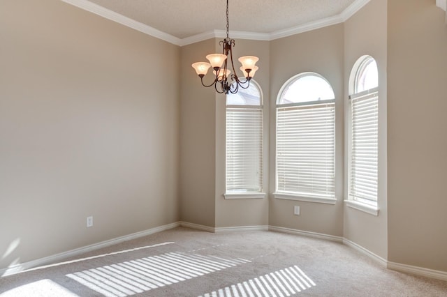 carpeted empty room with ornamental molding, a chandelier, and a wealth of natural light