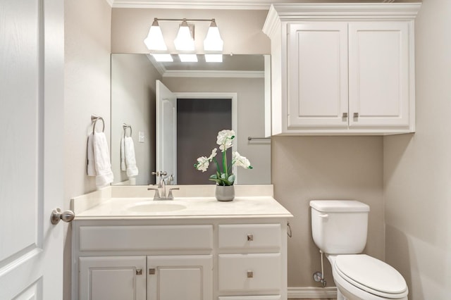 bathroom with vanity, crown molding, and toilet