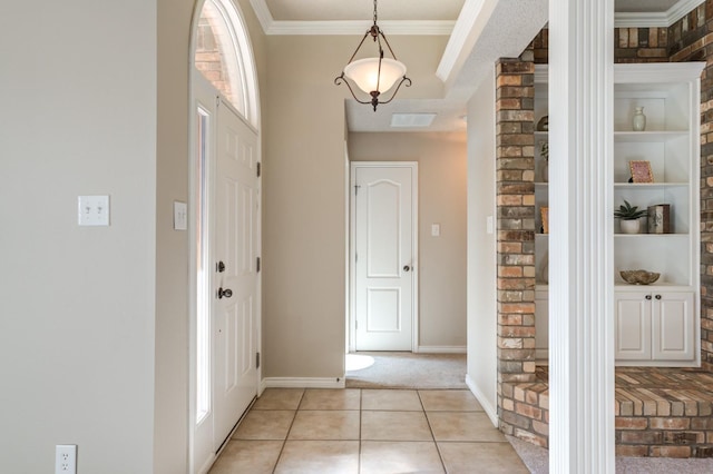 entrance foyer featuring ornamental molding and light tile patterned flooring