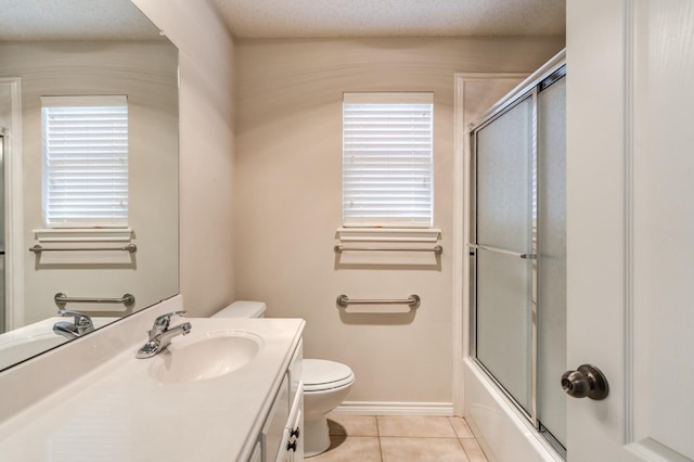 full bathroom with combined bath / shower with glass door, vanity, a textured ceiling, tile patterned floors, and toilet