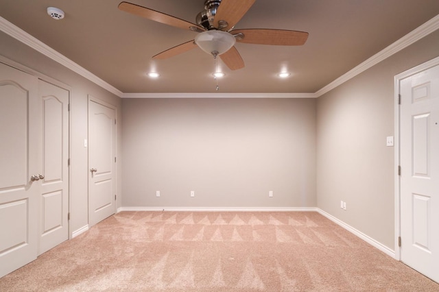 unfurnished bedroom with ornamental molding, light colored carpet, and ceiling fan