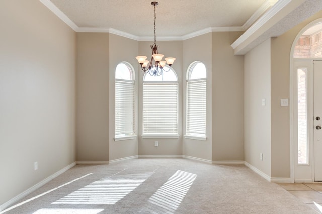 foyer entrance with an inviting chandelier, light colored carpet, crown molding, and a textured ceiling