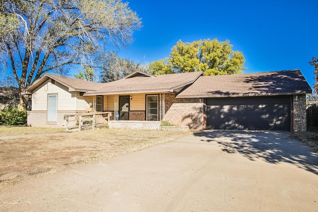 ranch-style house featuring a garage and a porch